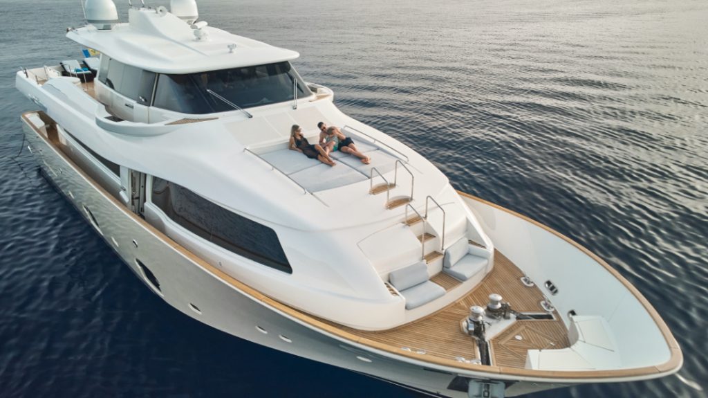 Navetta 26 Friend's Boat_Aerial view close up with couple on lounges 2_YACHT IN